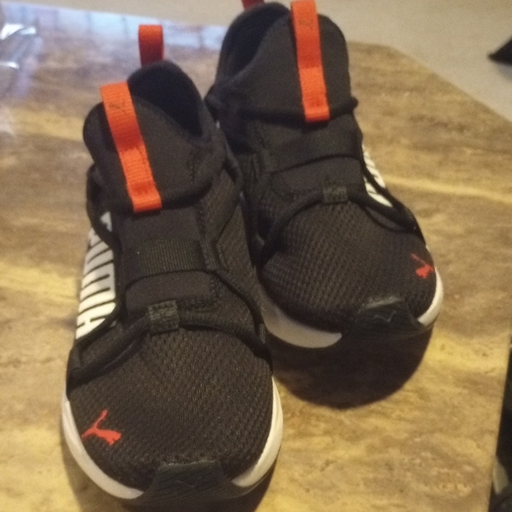 Puma big kids unisex Black Sneakers with Red Highlights